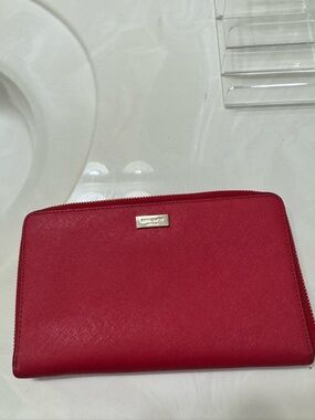 Kate spade long red zip-around leather wallet with gold logo plaque